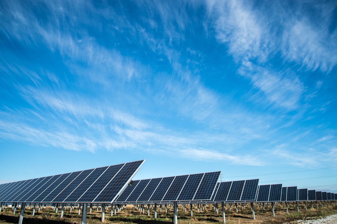 Solar panels under a blue sky Photo by American Public Power Association on Unsplash